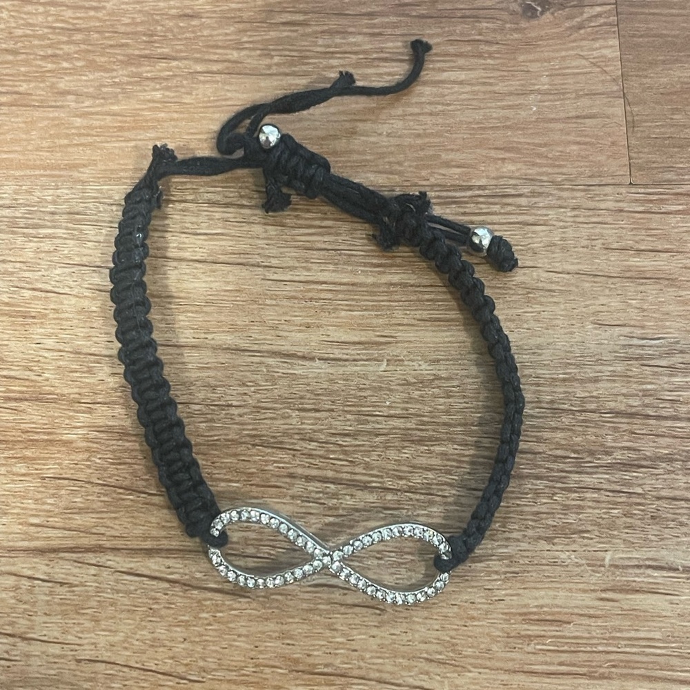 Black and silver toned infinity rhinestone pull tie bracelet​​​​​​​​